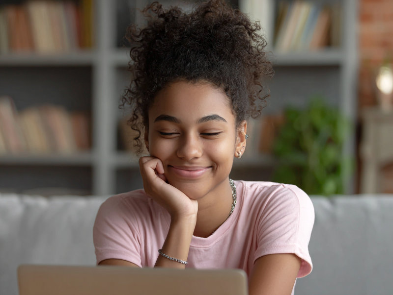 female hispanic student studying and smiling